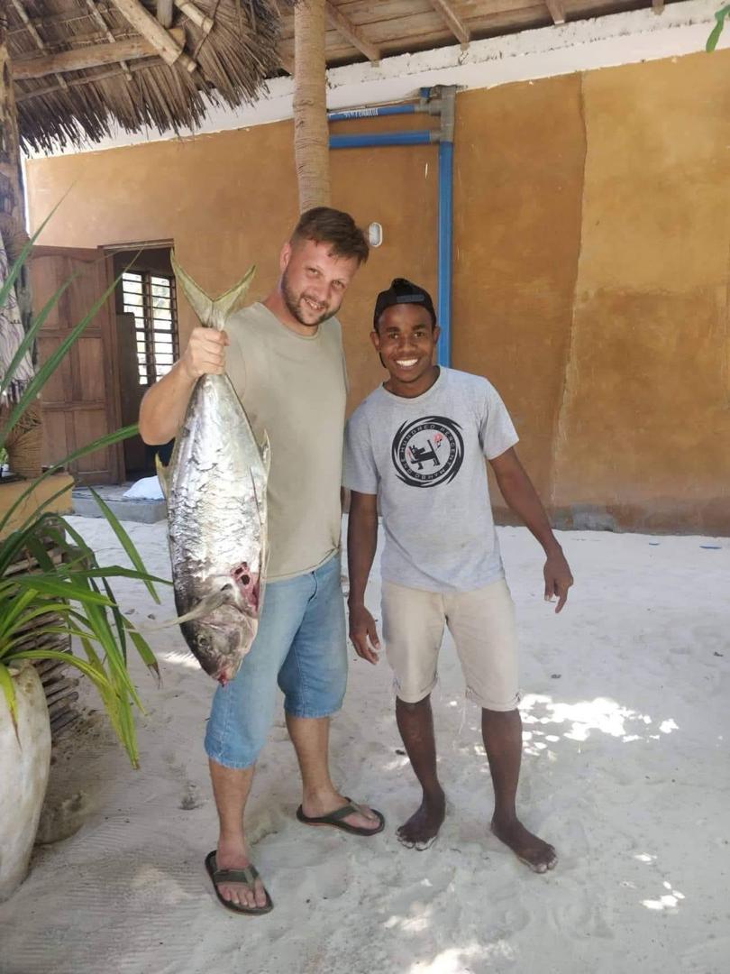 Guest holding a freshly caught fish on the Jambiani beach