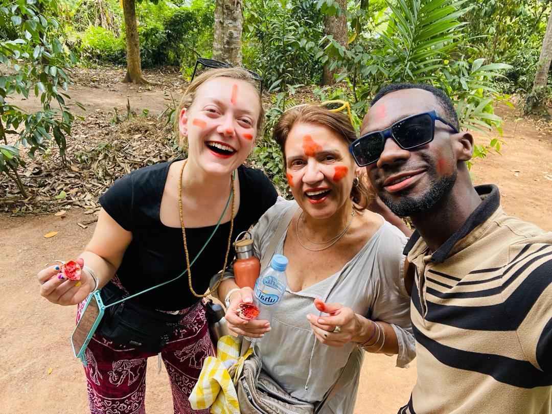 Guests with annatto face paint on a spice farm tour near Jambiani