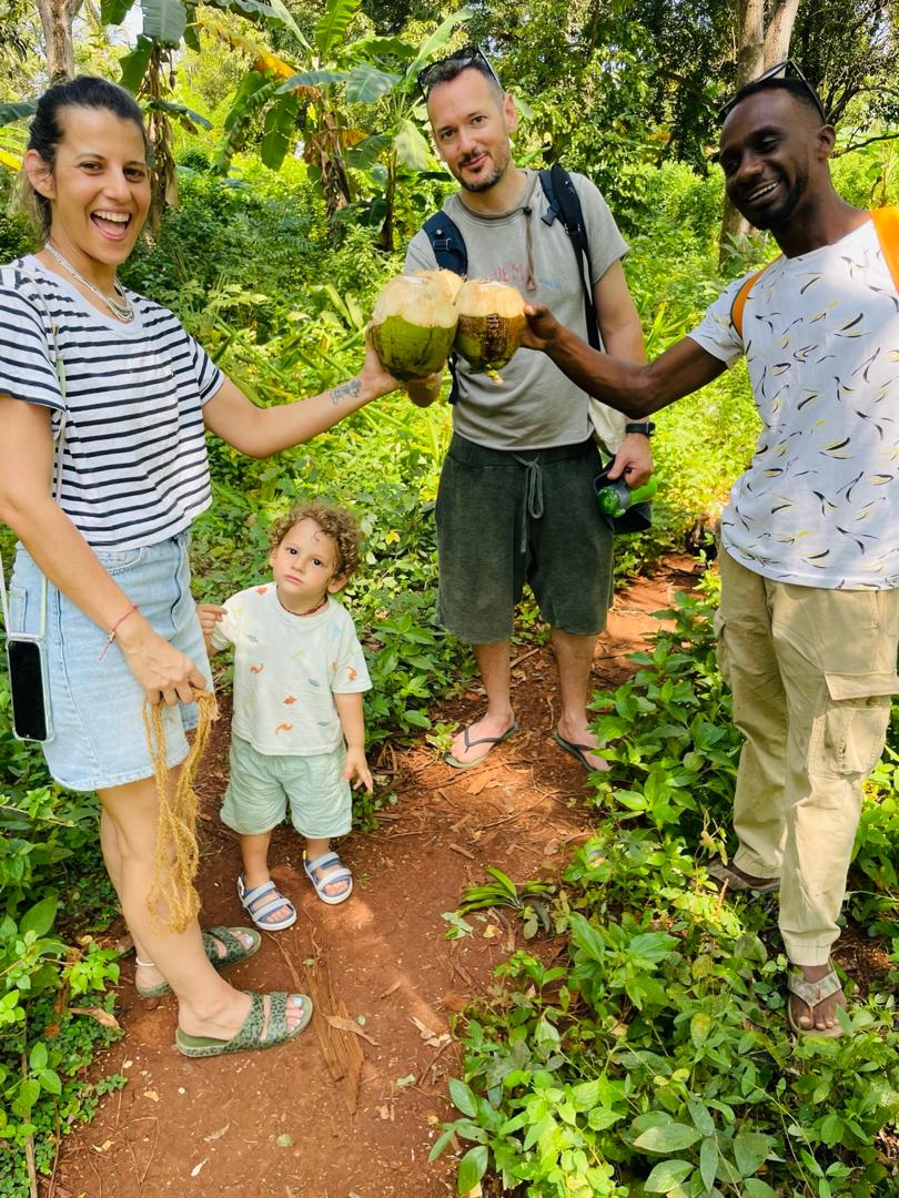Guests drinking from fresh coconuts on a spice farm walk near Jambiani